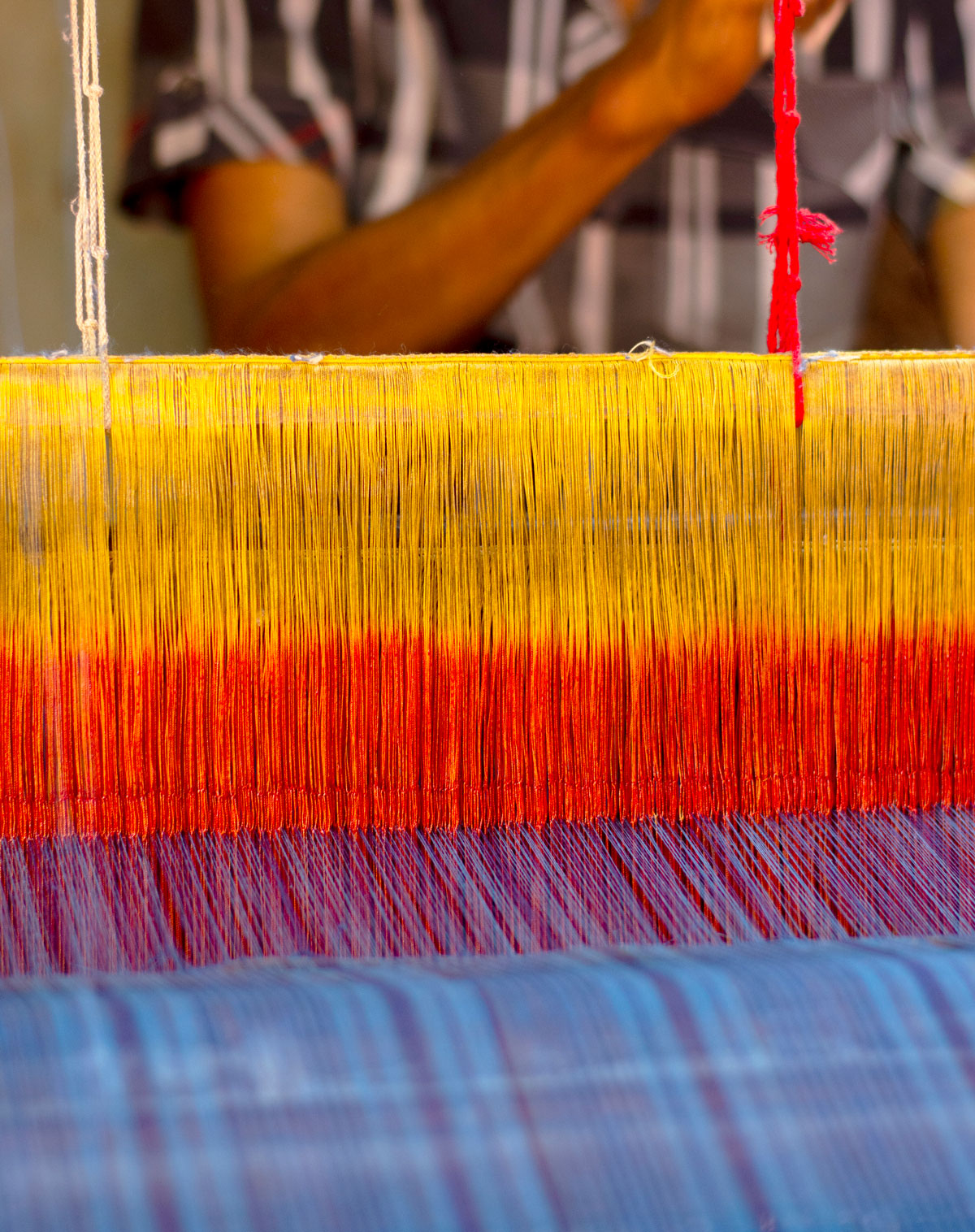 Colorful thread on a loom.